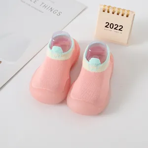 Detailed view of soft pink knitted baby walker shoes featuring anti-slip rubber soles