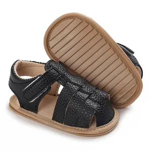 Close-up detail of black faux leather baby summer sandals with anti-slip soft rubber sole