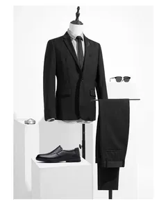 Elegant professional view of premium black leather slip-on shoes paired with a pinstripe suit