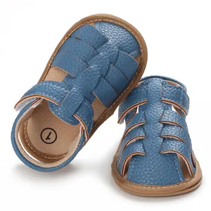 Detailed macro view of blue woven leather baby sandals featuring flexible soft brown soles