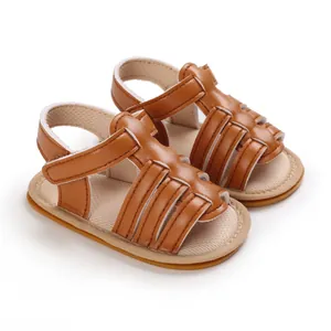 Detail view of brown baby walking sandals with soft non-slip rubber soles for newborns