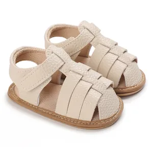 Side view of beige soft sole baby sandals with woven texture straps for 0-1 year olds