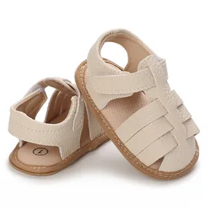 Close-up of beige soft-sole baby sandals with hook-and-loop straps and leather texture