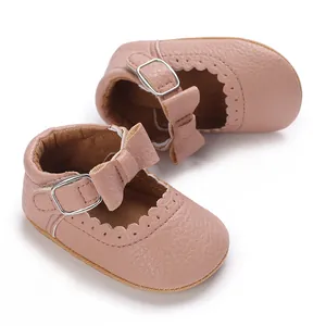 Detailed close-up of pink baby girl princess walking shoes with bow and soft sole