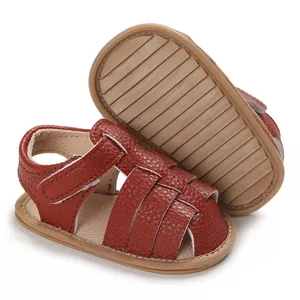 Detail shot of reddish-brown soft sole baby sandals with anti-slip rubber texture