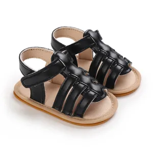 Close-up view of black baby sandals with non-slip rubber soles for newborn toddlers