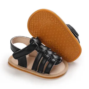 Detail of black baby walking shoes featuring non-slip textured rubber sole for infants