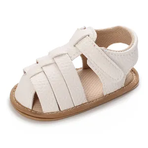 Close-up of white soft-soled baby summer sandal with woven straps and velcro closure