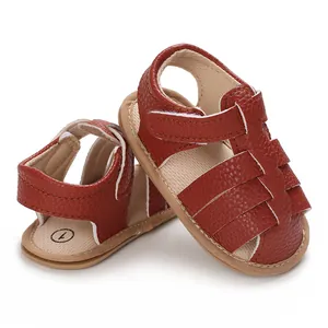 Close-up detail of reddish-brown soft sole baby sandals featuring breathable woven design.
