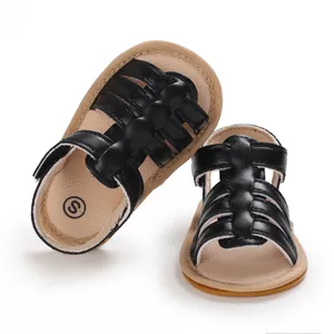 Close-up of black baby pre-walker sandals with woven straps and anti-slip rubber sole