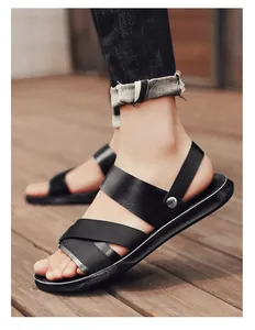 Close-up of men's black PU leather sandals with cross straps and non-slip soles.
