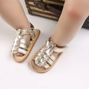 Detailed view of gold baby walking shoes with soft non-slip soles for infants.