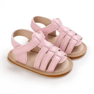 Close-up view of pink infant pre-walker sandals with anti-slip rubber sole and velcro strap