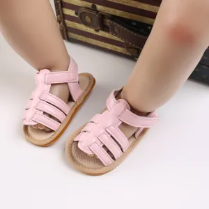 Detail of pink baby sandals with soft anti-slip soles and adjustable velcro straps.