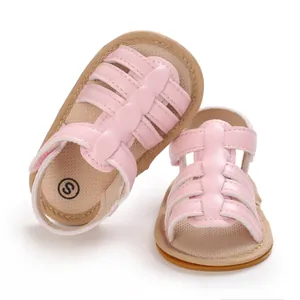 Close-up of pink infant walking sandals featuring non-slip soles and soft leather straps