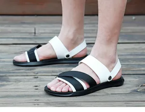 Men's outdoor summer sandals featuring black and white cross straps on wooden deck.