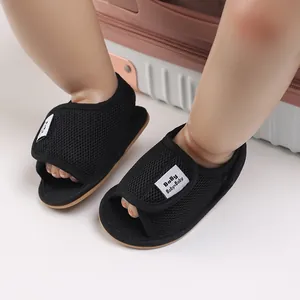 Detail of breathable black mesh infant pre-walker shoes with soft rubber sole