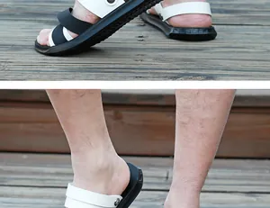 Close-up of men's black and white PU leather sandals on a wooden deck background