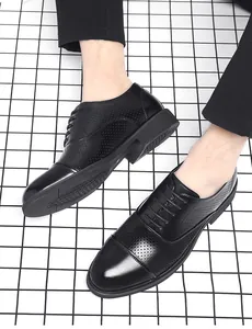 Close-up detail of breathable black leather perforated men's Oxford dress shoes