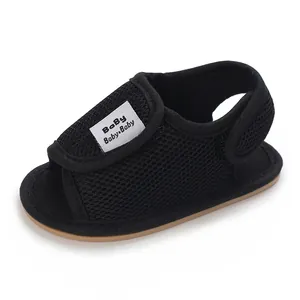 Close-up of breathable black mesh baby walking sandals with soft rubber soles.