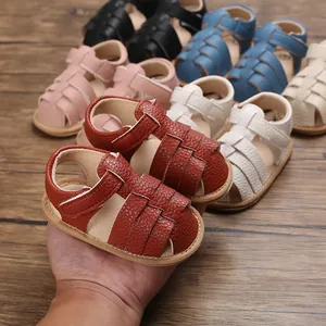 Detailed view of leather-textured baby sandals with non-slip soles and adjustable straps