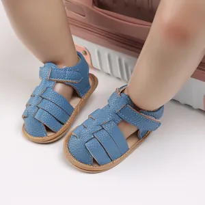 Detailed close-up of blue soft-sole baby sandals with woven texture and velcro strap.