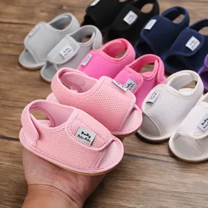 Close-up detail of soft mesh baby sandals in various colors for 0-1 year old infants.