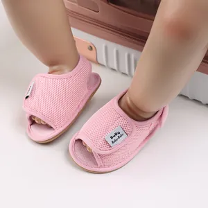 Close-up of pink breathable mesh baby walking shoes with soft non-slip soles.