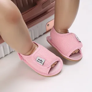 Detailed view of pink mesh baby walking sandals with soft rubber sole for summer travel