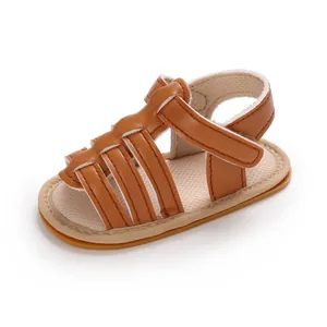 Close-up detail of a brown baby sandal featuring soft PU leather straps and a durable rubber sole