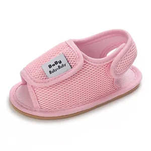 Close-up detail of a pink breathable mesh infant sandal with a soft brown rubber sole