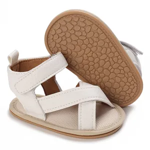 Détail de sandales blanches pour bébé en similicuir avec semelles souples antidérapantes