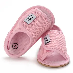 Close-up of pink infant walking shoes with breathable mesh and soft rubber sole