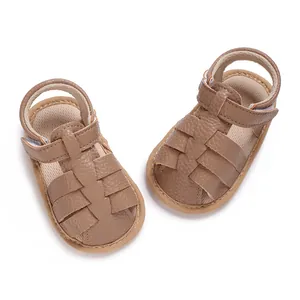 Detailed macro view of brown soft-soled baby sandals showing leather texture and straps.
