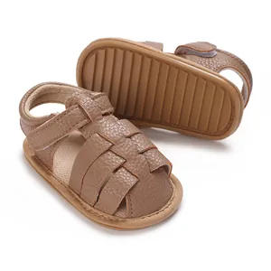 Close-up of brown faux leather baby sandals with non-slip textured sole for toddlers