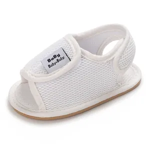 Close-up of white breathable mesh baby walking shoes with soft rubber soles for summer