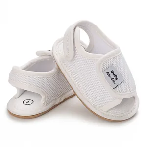 Close-up of white mesh baby walking shoes with adjustable strap and non-slip sole