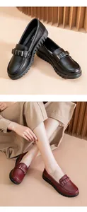 Close-up detail of soft sole loafers in black and burgundy with golden metal buckle
