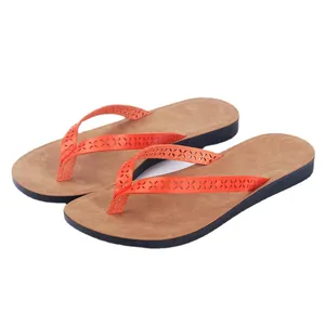 Stylish orange PU leather flip-flops for women with laser-cut patterns and brown footbed