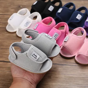 Close-up of breathable mesh baby sandals in various colors with adjustable velcro straps.