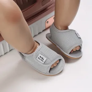 Detailed close-up of grey mesh baby walking shoes with soft non-slip rubber soles