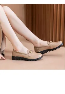 Side view of comfortable beige women's loafers with thick black anti-slip soles
