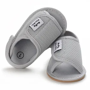 Close-up detail of breathable grey mesh baby sandals featuring secure Velcro strap closure