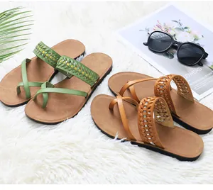 Stylish women's flat beach sandals featuring braided hollow straps in green and tan