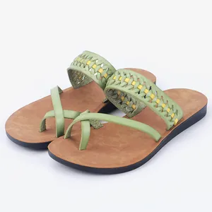 Stylish women's flat beach sandals featuring green braided leather straps and brown footbed