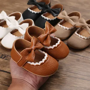 Detailed view of baby soft sole walker shoes with elegant bow and scallop trim