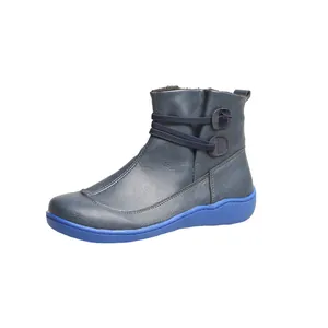 Stylish women's blue leather ankle boots featuring elastic strap detail and flat sole