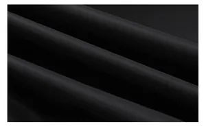 Close-up macro detail of premium black windbreaker fabric for men's casual flight jacket