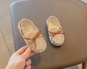 Toddler British style slip-on moccasins featuring cute brown bow and beige suede texture