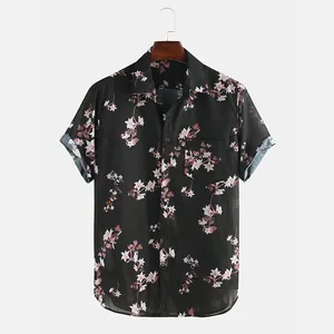 Front view detail of a men's black short-sleeve shirt with elegant pink floral patterns.
